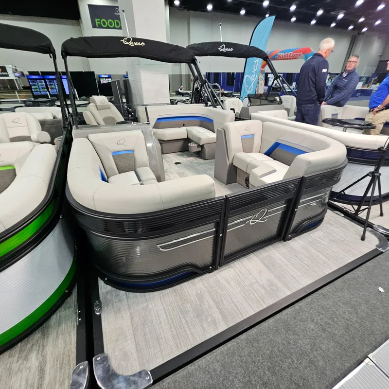 Slide: The Image of 2025 Qwest L18 Lanai pontoon boat displayed at an indoor exhibition. - 0