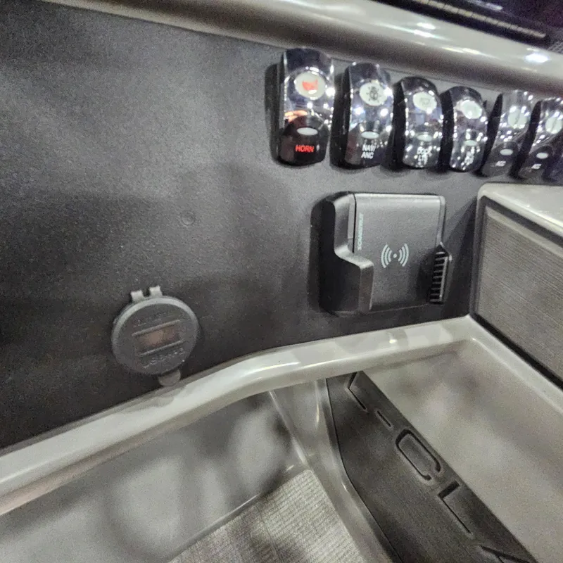 Slide: The Image of Control panel of 2025 Qwest L18 Lanai with switches and wireless charging pad. - 10