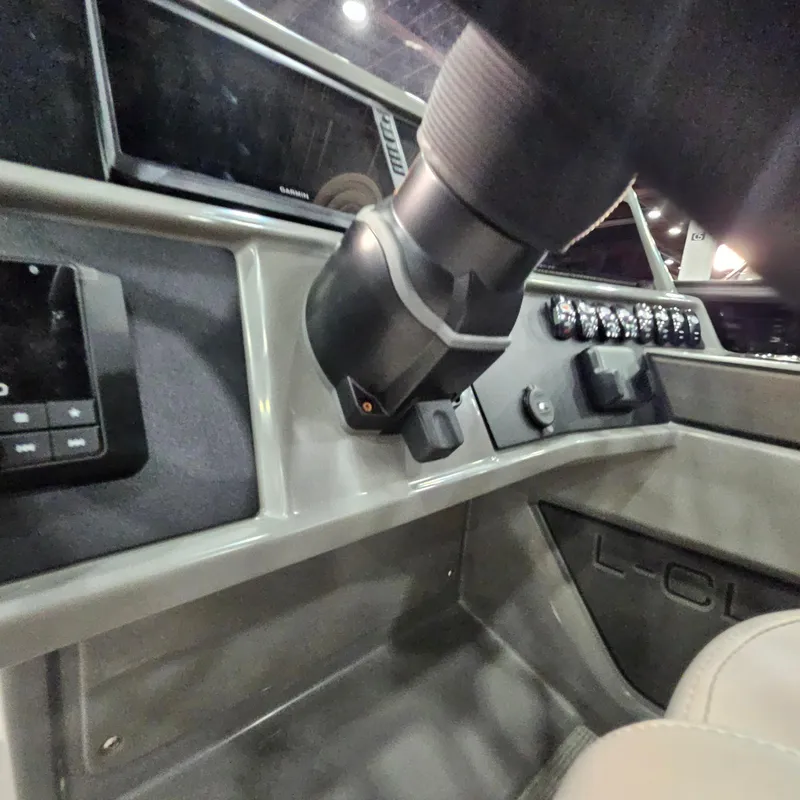 Slide: The Image of Dashboard of 2025 Qwest L18 Lanai boat with steering and controls. - 13