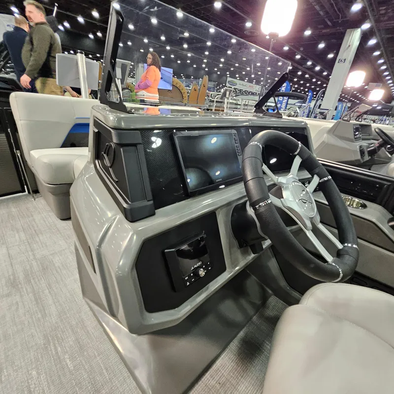 Slide: The Image of Interior view of 2025 Qwest L18 Lanai boat dashboard with steering wheel and controls. - 14