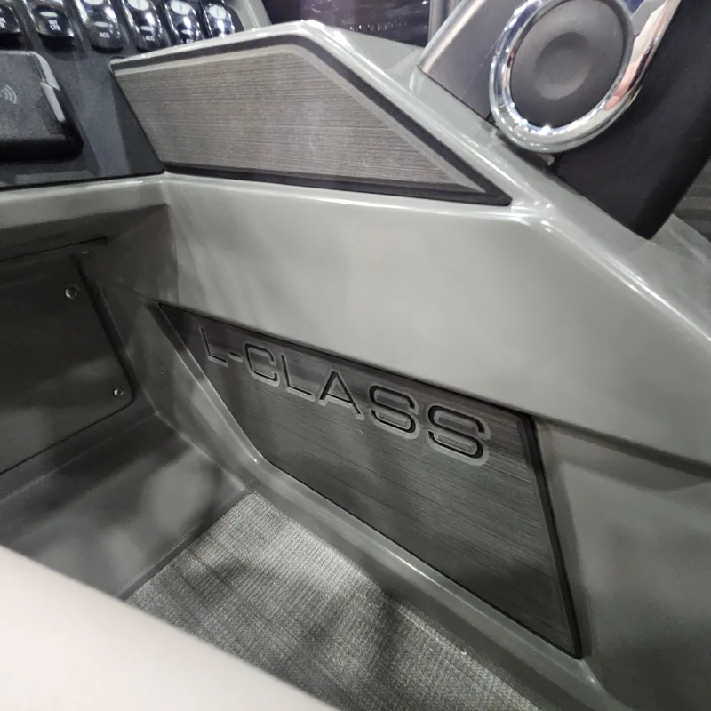 Slide: The Image of Interior of 2025 Qwest L18 Lanai boat, featuring L-Class branding and sleek design. - 16
