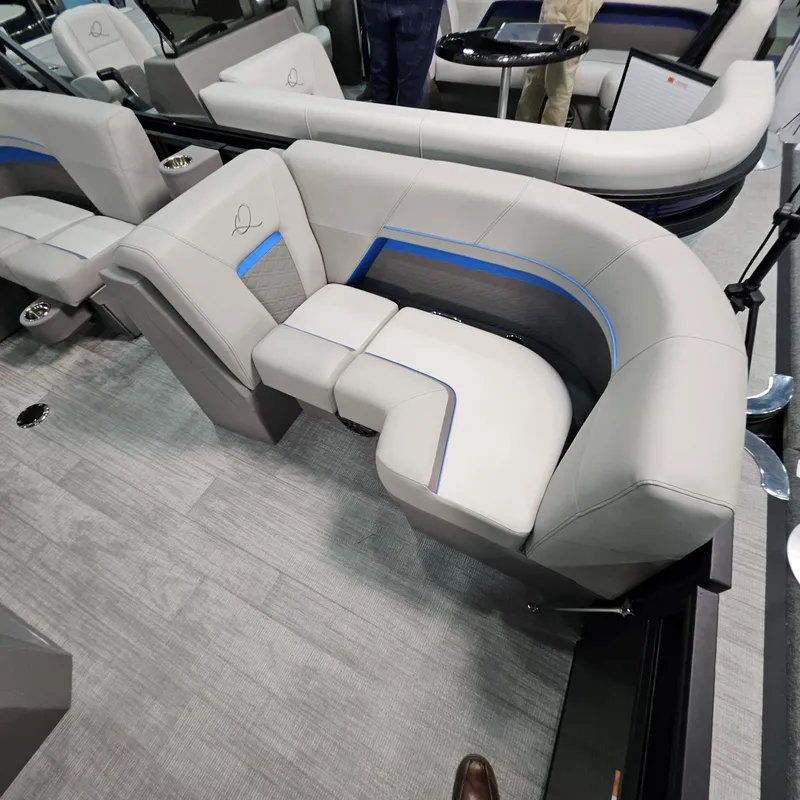 Slide: The Image of 2025 Qwest L18 Lanai boat interior with modern gray seating and blue accents. - 21