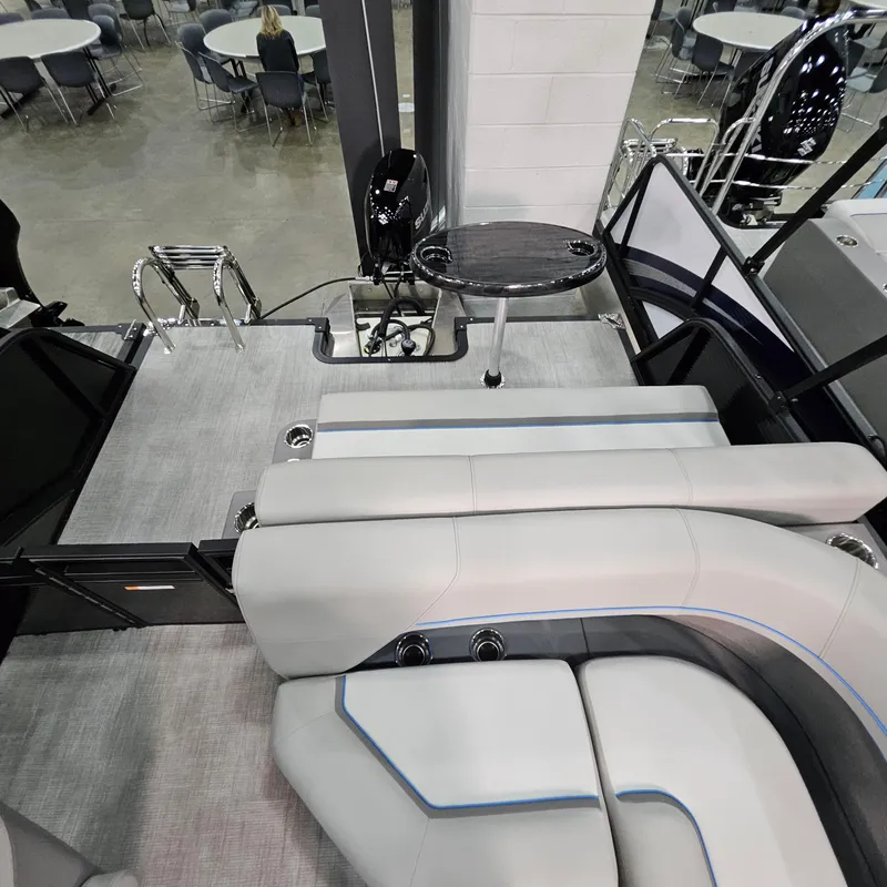Slide: The Image of Luxurious interior of 2025 Qwest L18 Lanai pontoon boat with sleek seating and table. - 7