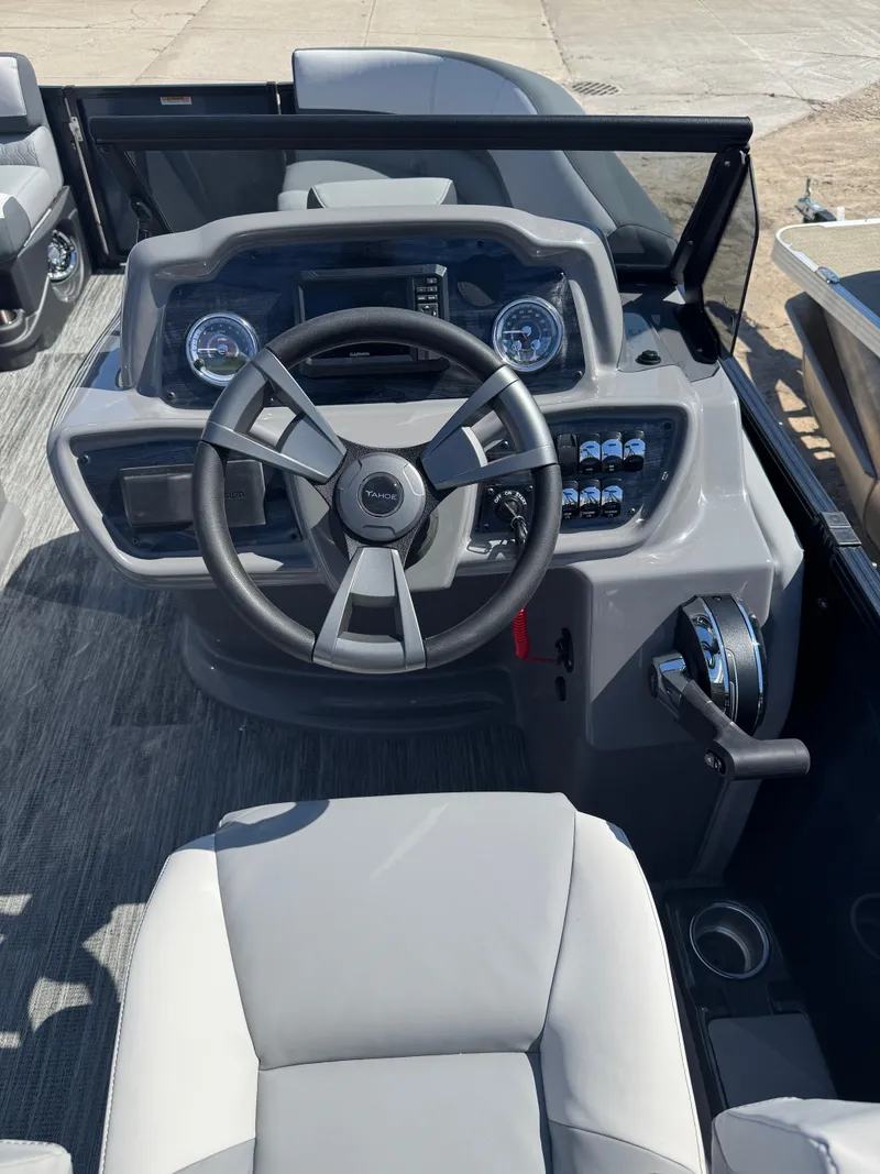 Slide: The Image of 2025 Tahoe Pontoon LTZ Versatile Rear Bench Windshield dashboard with modern steering and controls. - 11