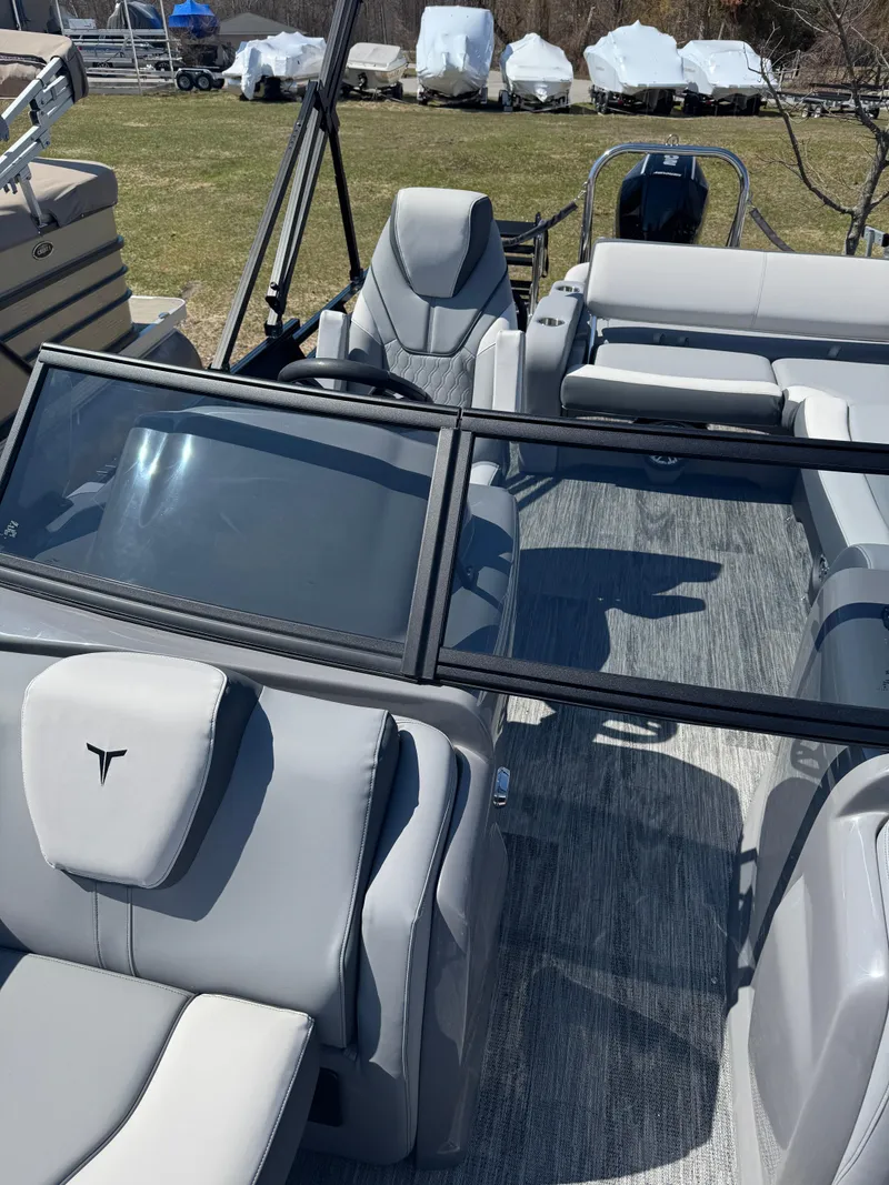 Slide: The Image of 2025 Tahoe Pontoon LTZ Versatile Rear Bench Windshield with sleek gray interior design. - 14