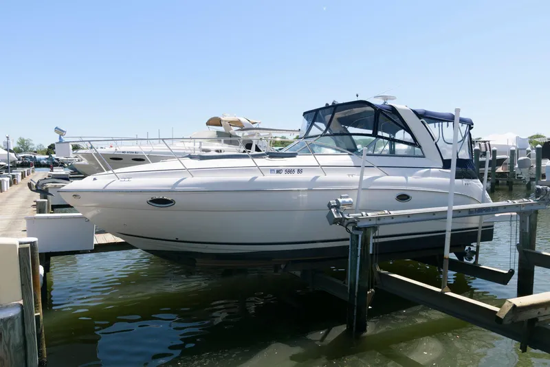 Slide: The Image of 2004 Rinker Fiesta Vee 312 boat docked at marina, side view. - 1
