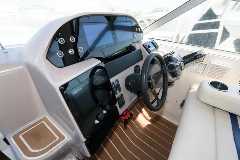 Slide: The Image of 2004 Rinker Fiesta Vee 312 boat cockpit with modern controls and steering wheel. - 10