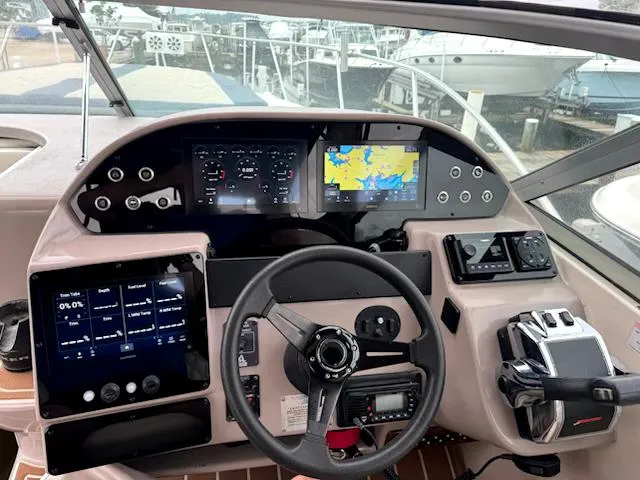 Slide: The Image of 2004 Rinker Fiesta Vee 312 boat dashboard with modern navigation and control systems. - 11