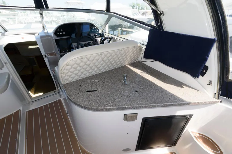 Slide: The Image of 2004 Rinker Fiesta Vee 312 boat interior with helm and seating area. - 15