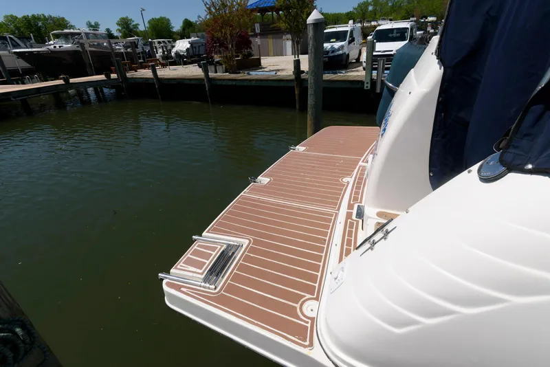 Slide: The Image of 2004 Rinker Fiesta Vee 312 boat docked with swim platform in marina. - 16