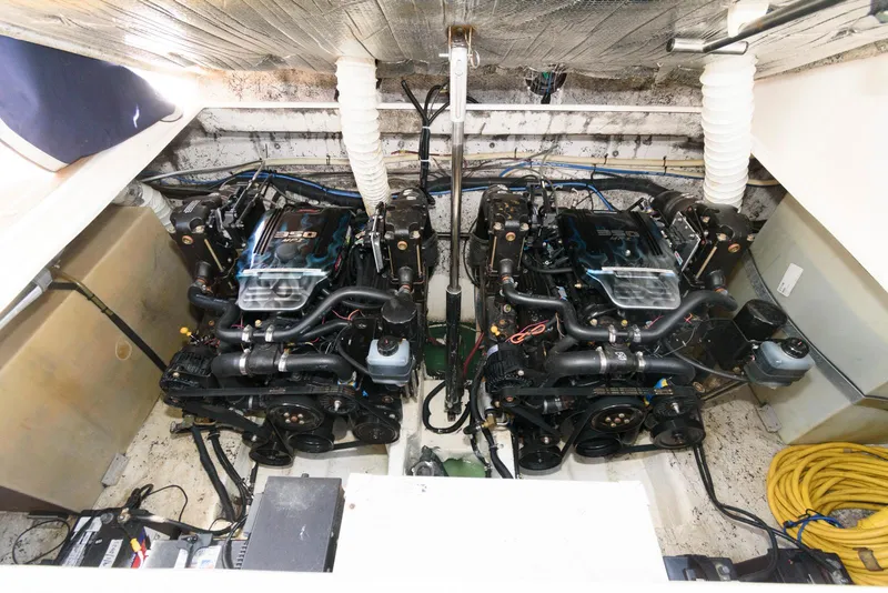 Slide: The Image of Engine compartment of 2004 Rinker Fiesta Vee 312 with dual inboard motors. - 23