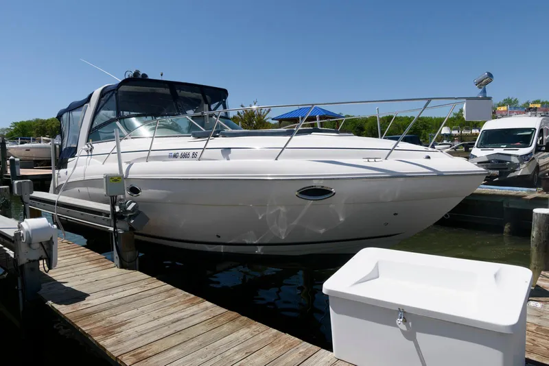 Slide: The Image of 2004 Rinker Fiesta Vee 312 boat docked at a marina under clear blue skies. - 3