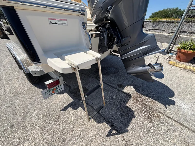 Slide: The Image of 2018 Scout 210 Dorado boat with outboard motor and foldable swim ladder. - 17