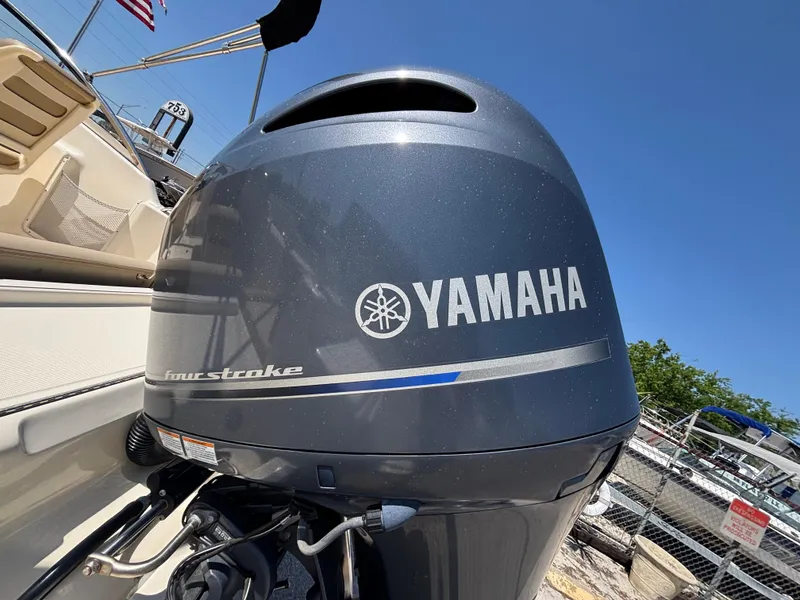 Slide: The Image of Yamaha outboard motor on 2018 Scout 210 Dorado boat, sunny day, American flag in background. - 19