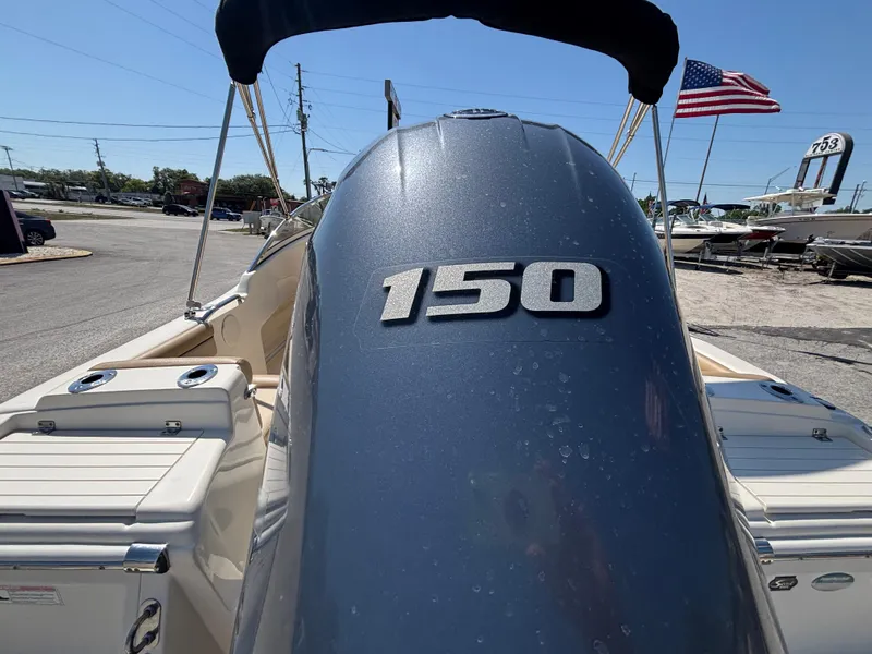 Slide: The Image of 2018 Scout 210 Dorado boat with 150 horsepower engine, American flag in background. - 20
