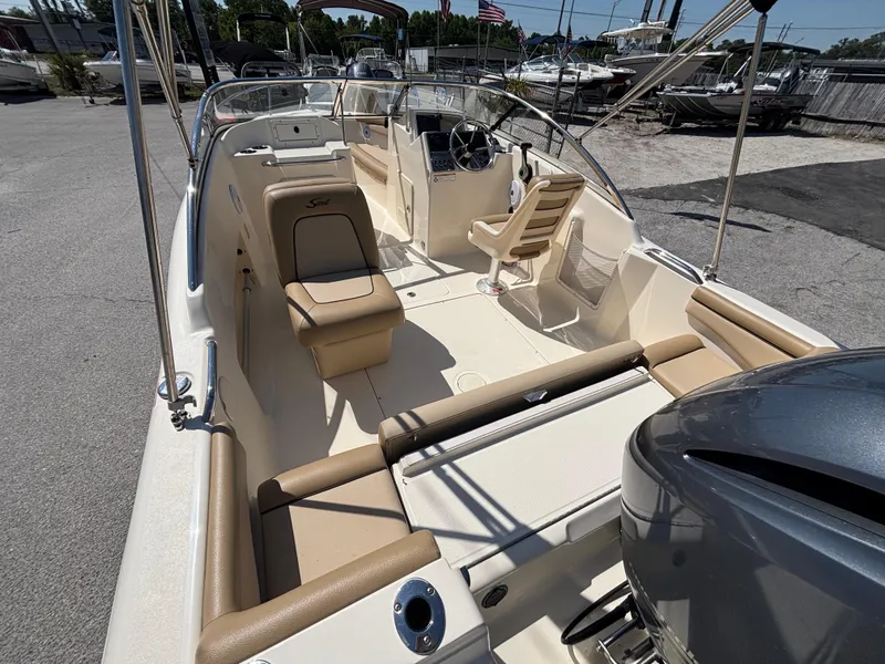 Slide: The Image of 2018 Scout 210 Dorado boat interior with seating and steering console. - 21