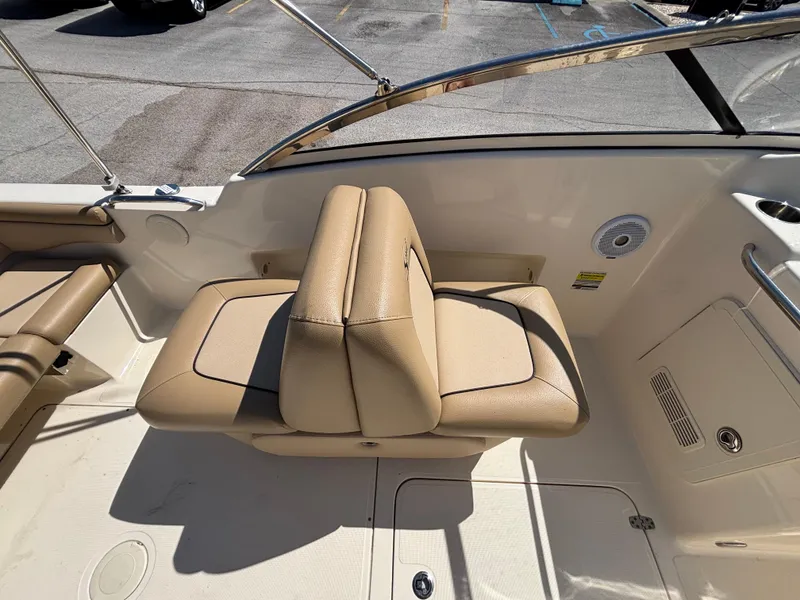 Slide: The Image of 2018 Scout 210 Dorado boat interior with beige seating and stainless steel railing. - 24