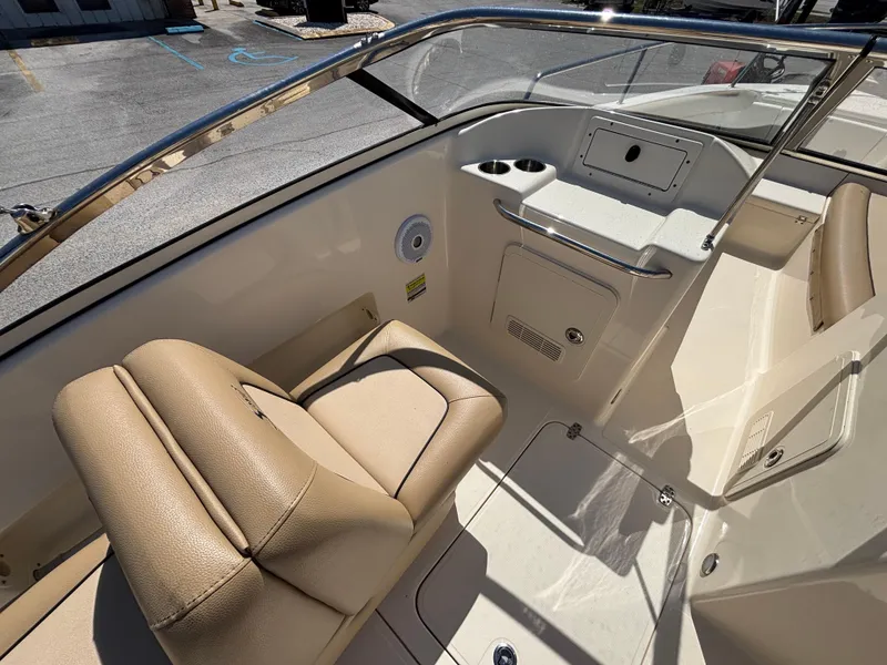 Slide: The Image of 2018 Scout 210 Dorado boat interior with beige seating and console. - 25