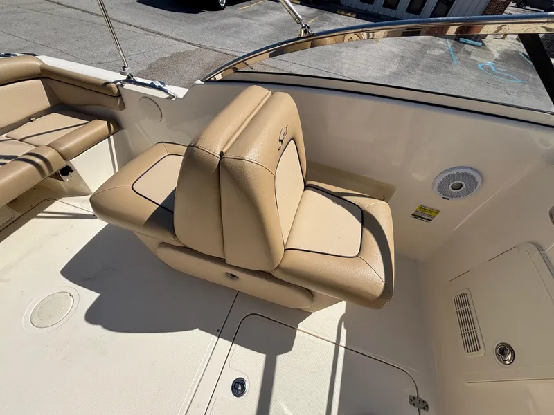Slide: The Image of 2018 Scout 210 Dorado boat interior with beige seating and speaker. - 33