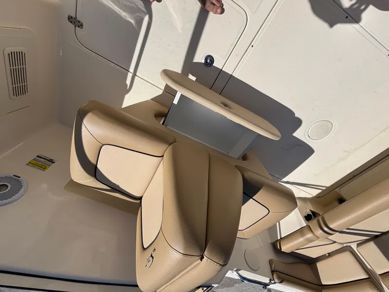 Slide: The Image of 2018 Scout 210 Dorado boat interior with beige seating and table. - 34