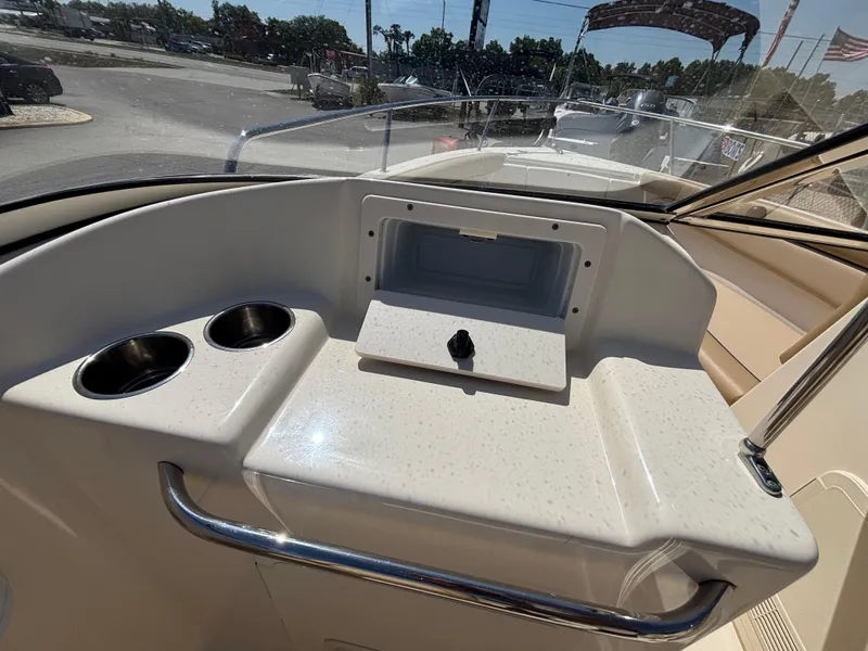 Slide: The Image of 2018 Scout 210 Dorado boat dashboard with cup holders and storage compartment. - 36