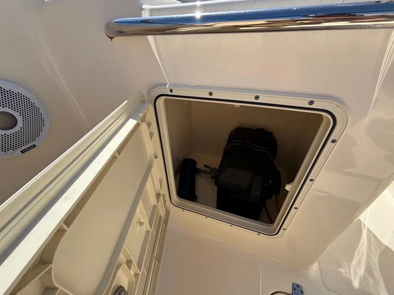 Slide: The Image of Storage compartment on a 2018 Scout 210 Dorado boat, featuring a speaker and railing. - 37