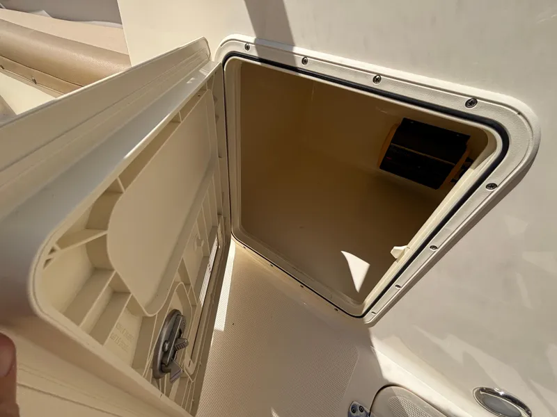 Slide: The Image of Open storage compartment on a 2018 Scout 210 Dorado boat. - 38