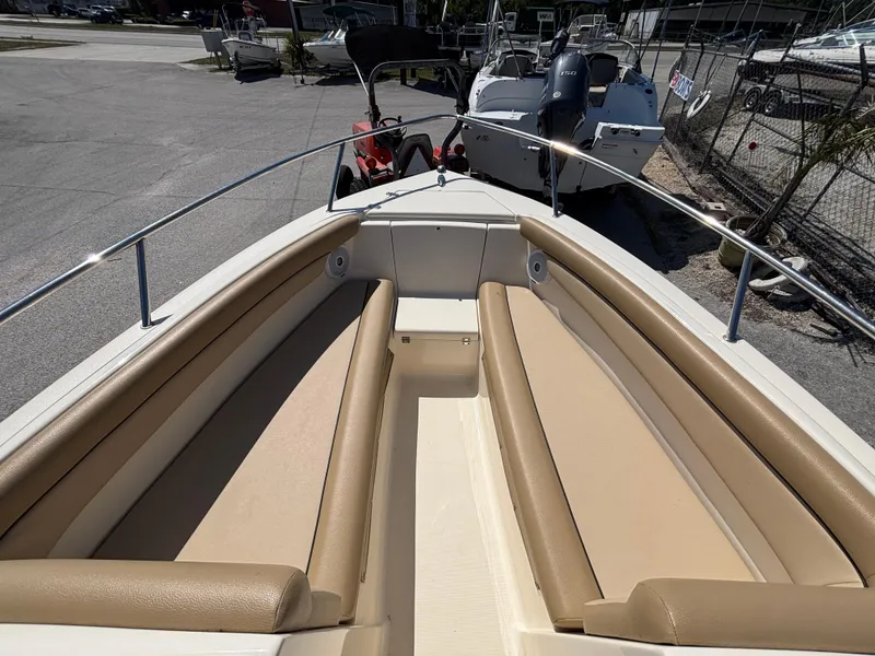 Slide: The Image of 2018 Scout 210 Dorado boat with tan seating, docked in a marina. - 39
