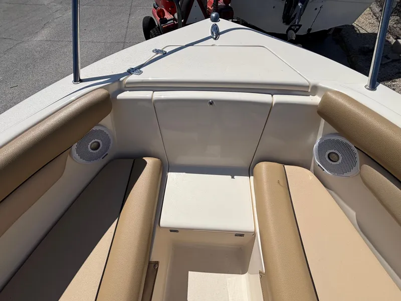 Slide: The Image of 2018 Scout 210 Dorado boat interior with beige seating and built-in speakers. - 42