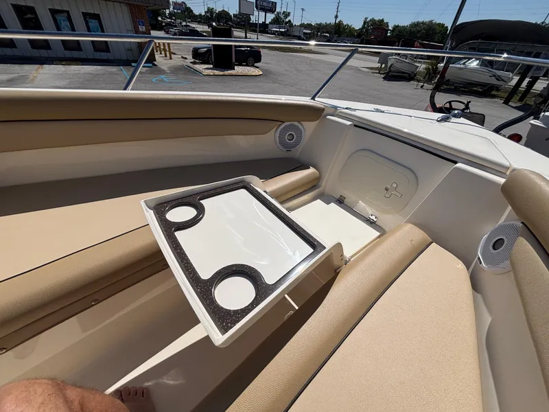 Slide: The Image of 2018 Scout 210 Dorado boat interior with beige seating and cup holder tray. - 43