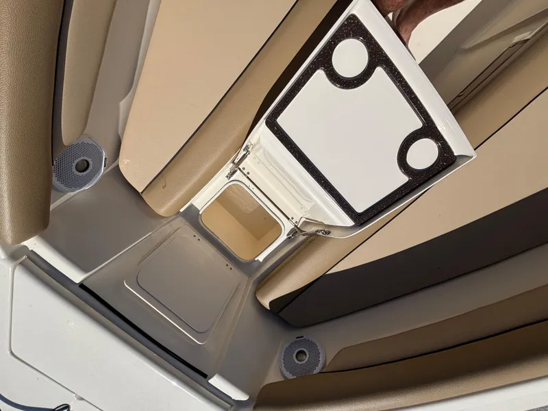 Slide: The Image of 2018 Scout 210 Dorado boat interior with beige seating and storage compartment. - 44