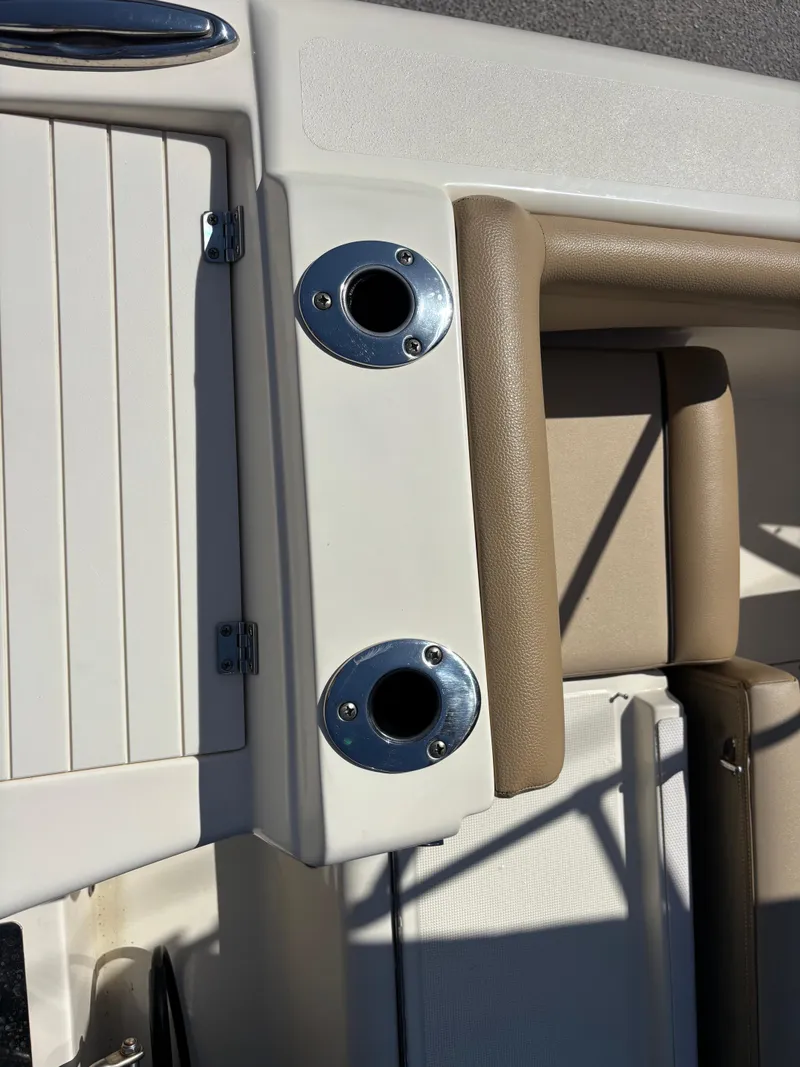 Slide: The Image of 2018 Scout 210 Dorado boat interior with rod holders and beige upholstery. - 49