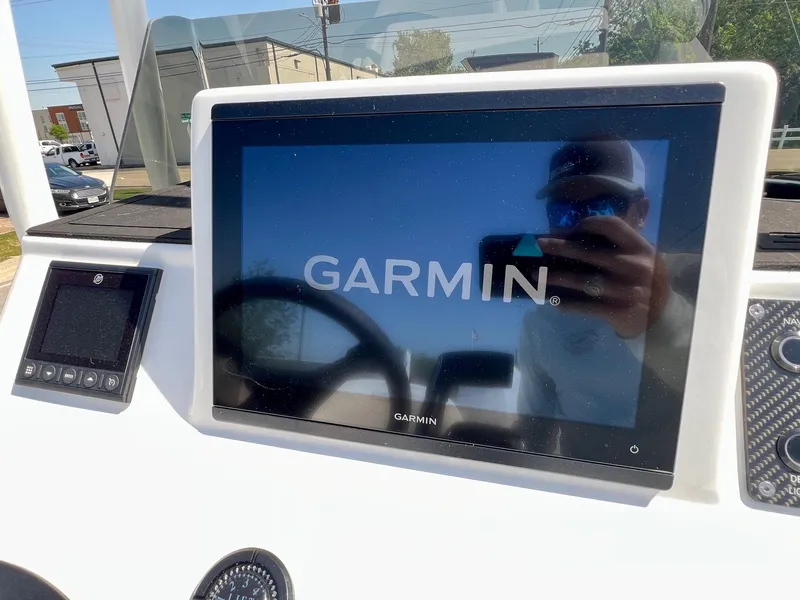 Slide: The Image of Garmin display on SCB S22 boat dashboard, 2025 model, with reflection of person. - 13