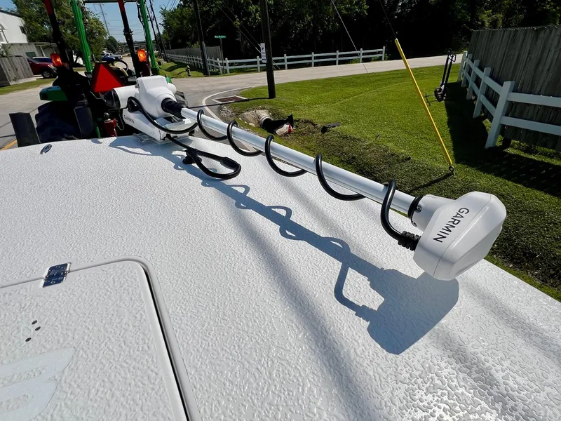 Slide: The Image of 2025 SCB S22 boat with Garmin equipment on deck, parked near a grassy area. - 14