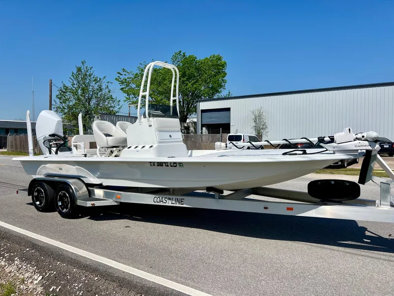 Slide: The Image of 2025 SCB S22 boat on trailer, parked outdoors, clear sky background. - 5