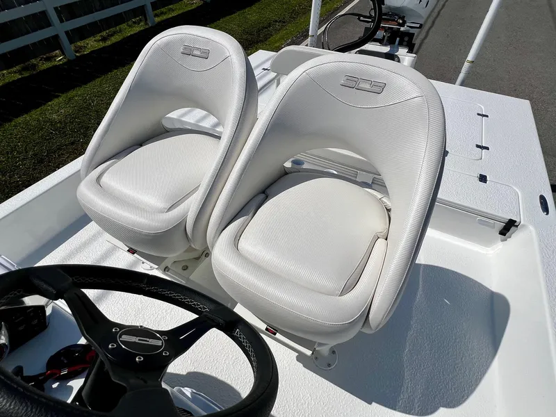 Slide: The Image of 2025 SCB S22 boat with dual white cushioned seats and steering wheel. - 9