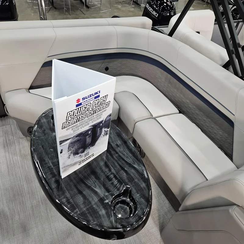 Slide: The Image of Luxurious seating in 2025 Qwest E 20RLS boat with sleek table and brochure. - 10