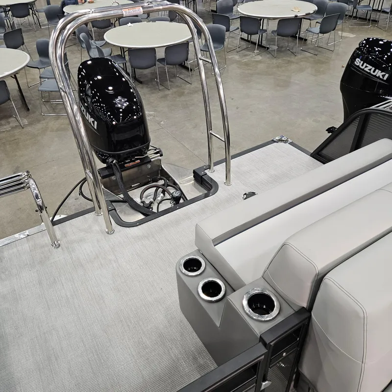 Slide: The Image of 2025 Qwest E 20RLS boat interior with Suzuki engine, seating, and cup holders. - 11