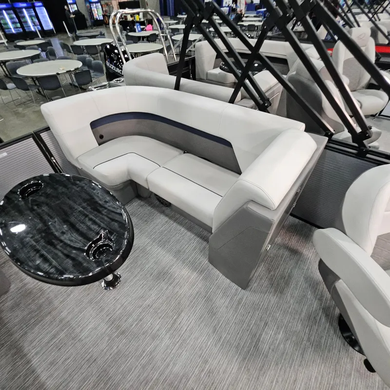 Slide: The Image of Luxurious seating area in 2025 Qwest E 20RLS boat with sleek design and modern table. - 22