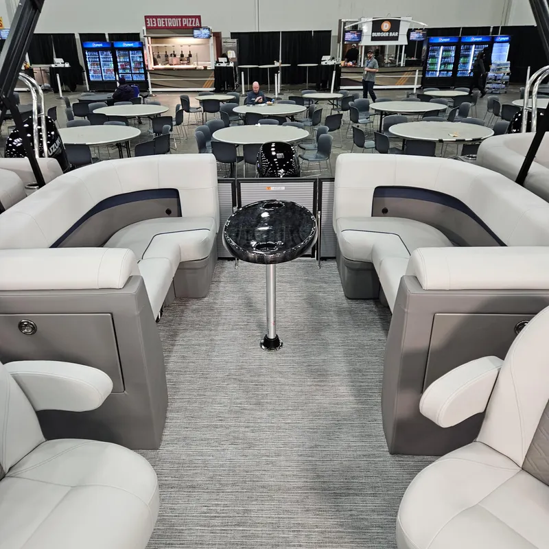 Slide: The Image of Luxurious interior of 2025 Qwest E 20RLS pontoon boat with plush seating and modern design. - 5