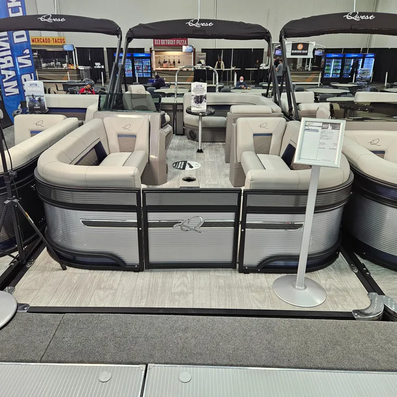 Slide: The Image of 2025 Qwest E 20RLS pontoon boat with luxurious seating on display indoors. - 7