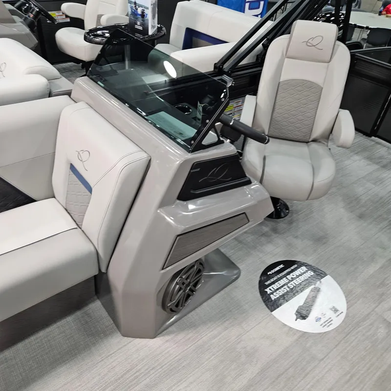 Slide: The Image of 2025 Qwest E 20RLS boat interior with modern seating and control console. - 8