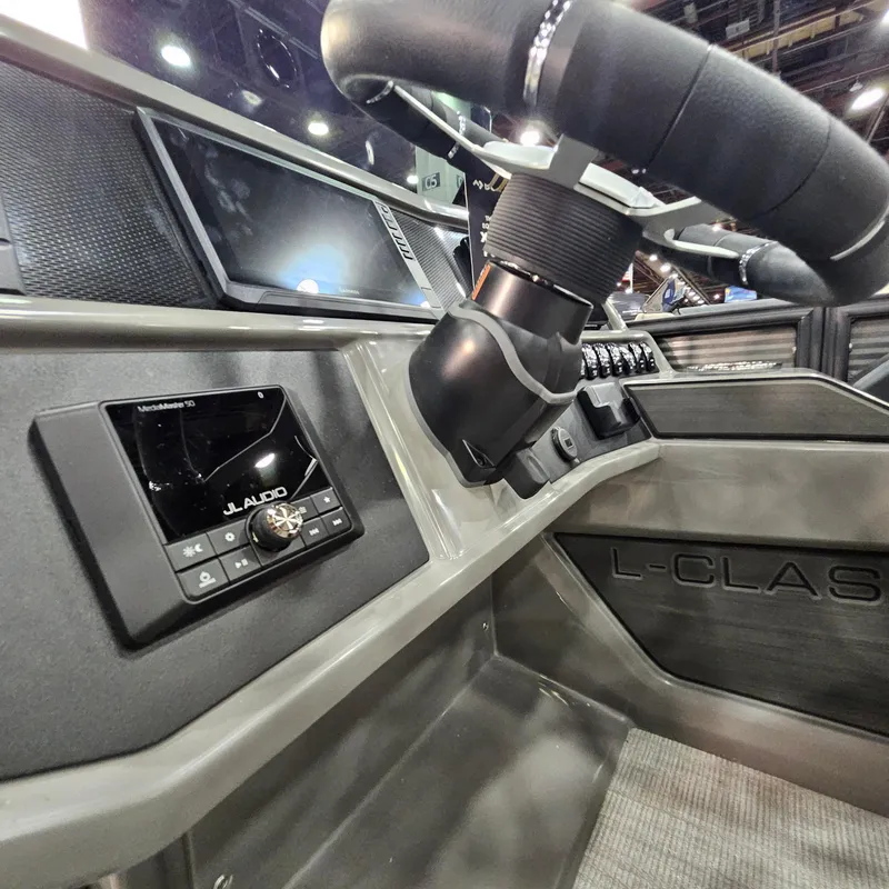 Slide: The Image of 2025 Qwest L22 Lanai boat dashboard with JL Audio system and steering wheel. - 14