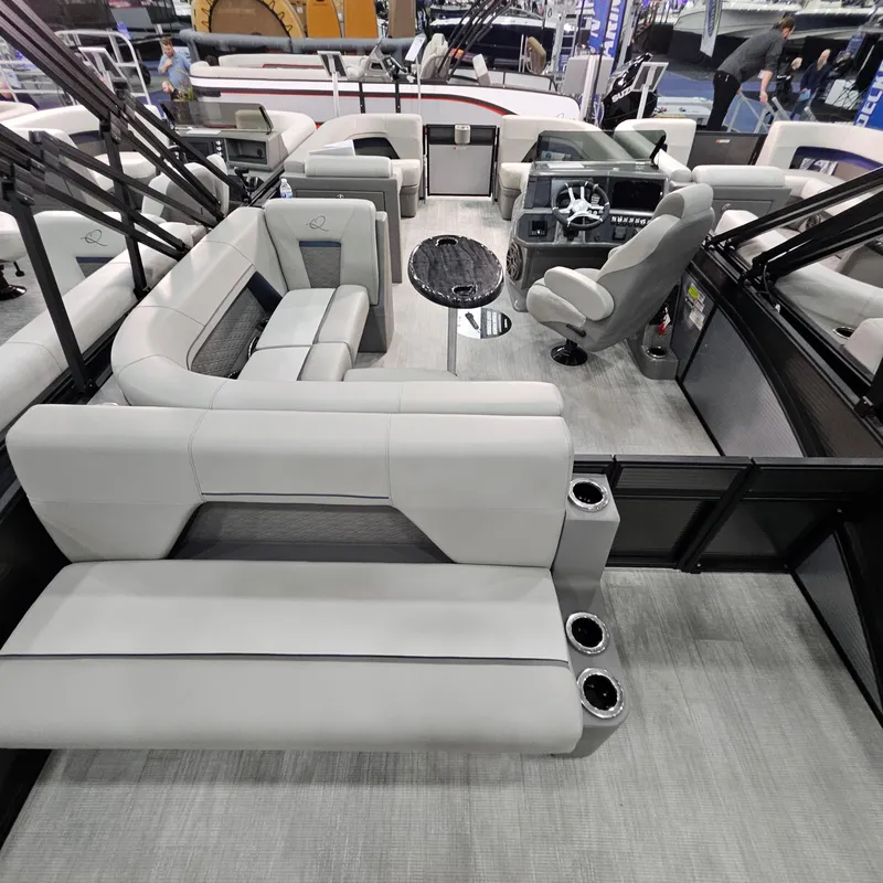 Slide: The Image of 2025 Qwest L22 Lanai pontoon boat interior with modern seating and steering console. - 16