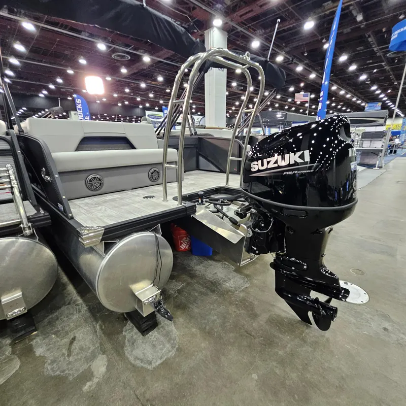 Slide: The Image of 2025 Qwest L22 Lanai pontoon boat with Suzuki outboard motor at indoor exhibition. - 17