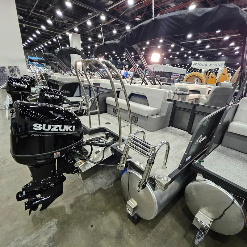 Slide: The Image of 2025 Qwest L22 Lanai pontoon boat with Suzuki outboard motor at indoor exhibition. - 19