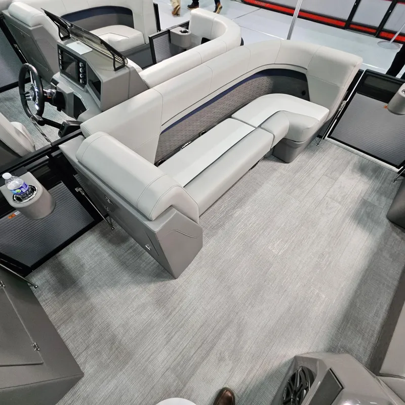 Slide: The Image of Interior of 2025 Qwest L22 Lanai boat with modern seating and steering console. - 6