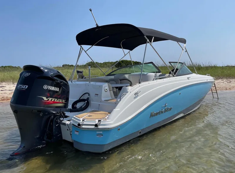 Slide: The Image of 2021 NauticStar 243 DC boat with Yamaha VMAX engine, anchored in shallow water. - 3