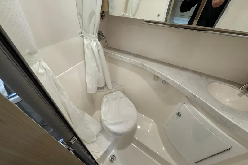 Slide: The Image of 2025 Regal 28 Express bathroom with shower, toilet, and sink in compact design. - 13