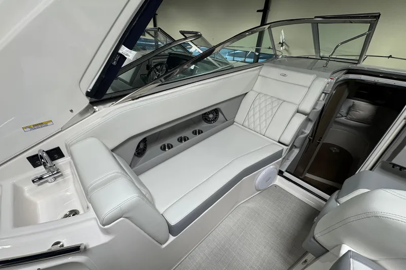 Slide: The Image of 2025 Regal 28 Express boat interior with white seating and modern design. - 7